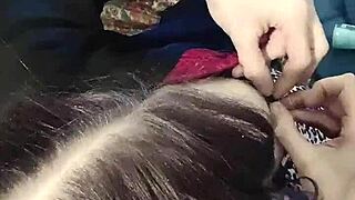 Brunette babe clamps nipples in close up