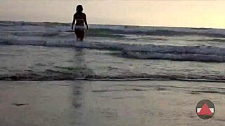 Asian model enjoys messy wet feet on beach day