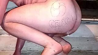 A gay man with painted lips shoves a whole pack of butter up his ass