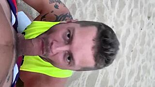 gay blowjob happens on public beach under the sun