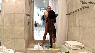 Sexy black milf enjoys a steamy shower with white sugar daddy in his penthouse.