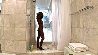 Sexy black milf enjoys a steamy shower with white sugar daddy in his penthouse.