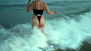 Blonde flashes perky tits and sucks hard on public beach