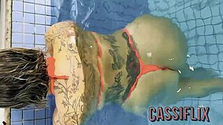 Teasing the tattooed guy at the pool led to sucking his monster cock in the shower.