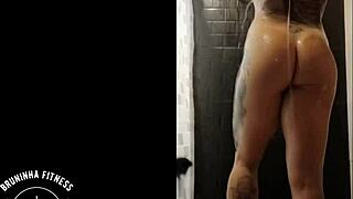 redhead depilates her pussy in the shower, leaving it smooth and wet