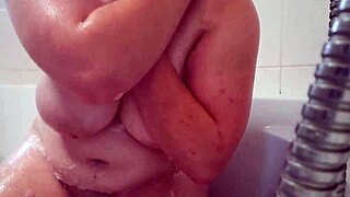 yo, watch this busty teen scrub and rub her soapy huge tits