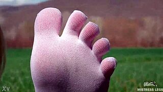 goddess feet in cute white socks on spring grass field