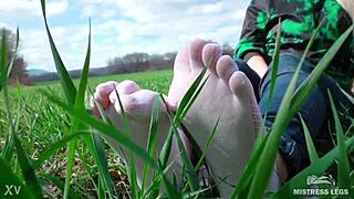 goddess feet in cute white socks on spring grass field