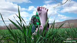 Goddess Feet In Cute White Socks With Jeans On The Spring Grass Field