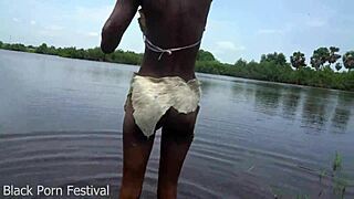 African tribe woman takes tourist cock in tropical stream
