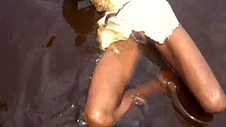 African tribe woman takes tourist cock in tropical stream