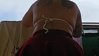 Naughty employee flashes big ass under skirt on balcony