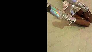 Beautiful model wears silver fishnet pantyhose with high heels and black boots