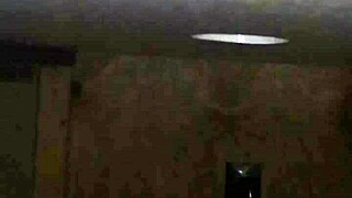 excited person performs deep action on large item through public hole in neutral setting