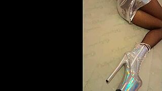 Beautiful model wears silver fishnet pantyhose with high heels and black boots