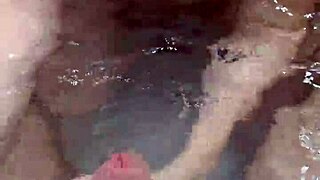 In the pool, a sexy couple's handjob session leads to an intense underwater cumshot