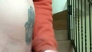 Masturbating on apartment stairs while neighbor talks on phone in garage