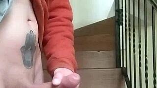 Masturbating on apartment stairs while neighbor talks on phone in garage