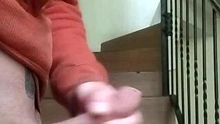 Masturbating on apartment stairs while neighbor talks on phone in garage