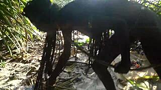 Naked skinny tribe woman prepares bow for hunting