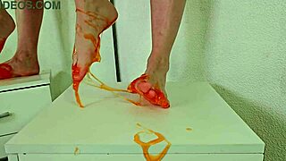 alice klay plays with orange slime on her feet
