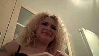 Curly blonde teases pretty pussy display in kitchen