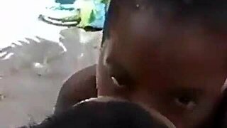 Two Liberian lesbians kiss and lick passionately in an uncompleted public building