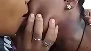 Two Liberian lesbians kiss and lick passionately in an uncompleted public building