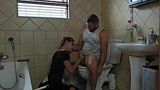 Petite individual engages in sucking activity on the toilet