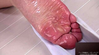 A woman applies lotion to her soles, moaning erotically