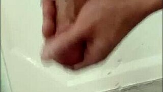 Blonde Blue-Eyed Bodybuilder Showers Muscular Body While Stroking Huge Cock