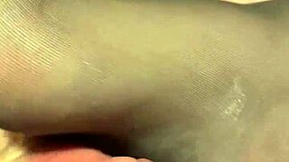 giving the hubby a footjob in black reinforced toe stockings