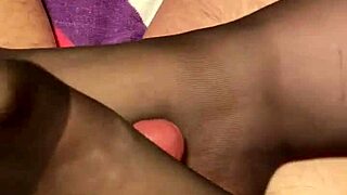 giving the hubby a footjob in black reinforced toe stockings