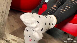 goddess slips off socks to tease wrinkled bare feet under desk