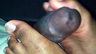 Damn ebony babe strokes black cock perfectly with her soft feet!