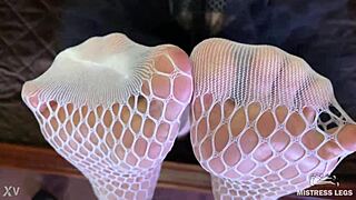 goddess teases with sexy feet and legs in cute white fishnets closeup on bed