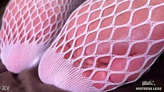 goddess teases with sexy feet and legs in cute white fishnets closeup on bed