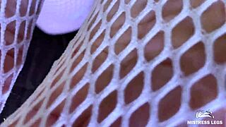 goddess teases with sexy feet and legs in cute white fishnets closeup on bed