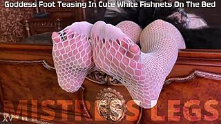 goddess teases with sexy feet and legs in cute white fishnets closeup on bed
