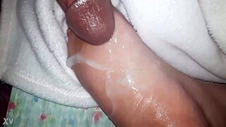 thick cumshot blasts across her slick oiled feet