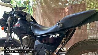 guy straps rocketman toy to his bike and shakes from the ride