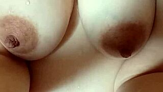 pregnant milf squeezes out her massive tits and hard nipples