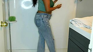 Latina soaks her jeans and panties before stripping for a messy wet shower tease