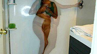 Latina soaks her jeans and panties before stripping for a messy wet shower tease