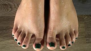colombian latina's oiled feet get damp cloth clean and green nails shown close up