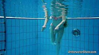 Hey, this cute young woman reveals her stunning smooth body while swimming underwater at the beach pool