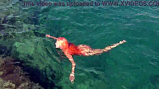 shaved naked girl flashing wet pussy by blue water?