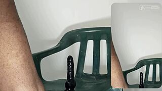 Johnazino rides huge black dildo deep in ass on green plastic chair