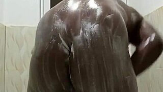 horny guy strokes huge black cock in steamy shower solo