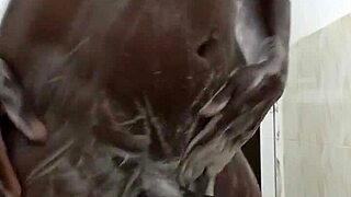 horny guy strokes huge black cock in steamy shower solo